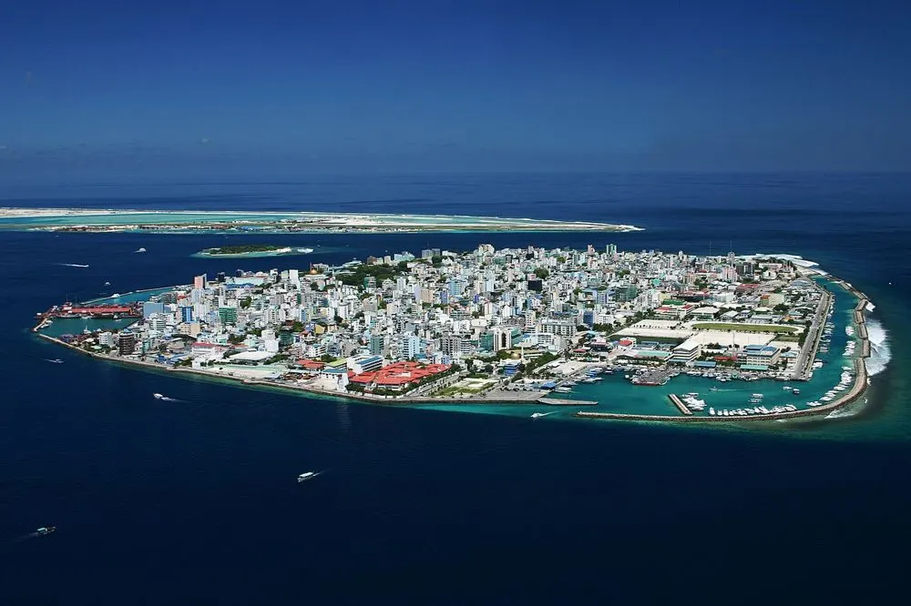 Aerial view of Malé, the whole island covered in buildings and surrounded by deep blue sea